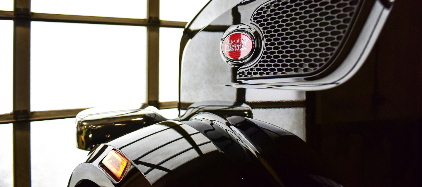 The hood of a TMC truck with Peterbilt logo