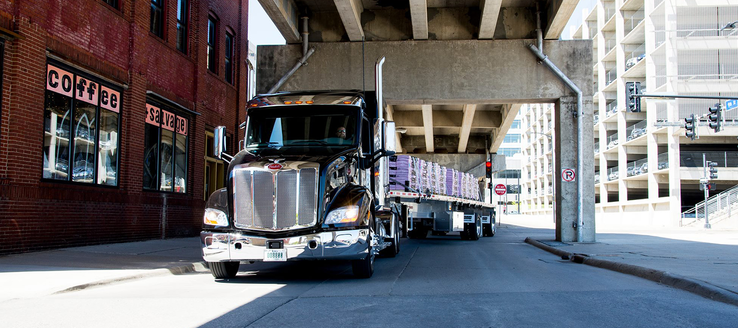TMC truck turning onto a street under and overpass